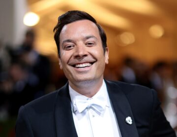 A close up of Jimmy Fallon smiling wearing a tux and white bow tie.