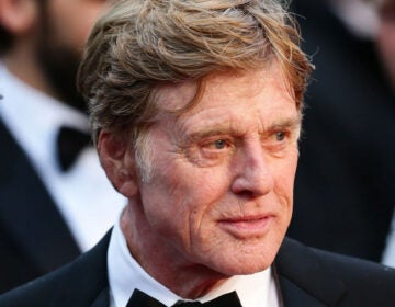 A close up head shot of an older Robert Redford in a tux.