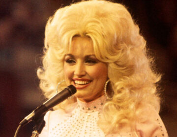 Dolly Parton sings in this image from 1976