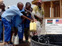 Children getting clean Drinking water from a well built by the Naval Mobile Construction Battalion in Kenya.