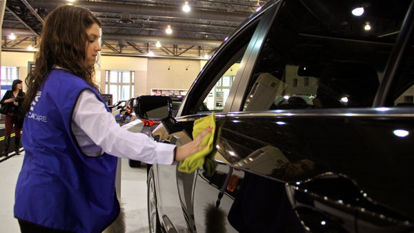 Auto show worker Stephanie Weitzenkern's job is to keep cars free of fingerprints and smudges left by visitors. 