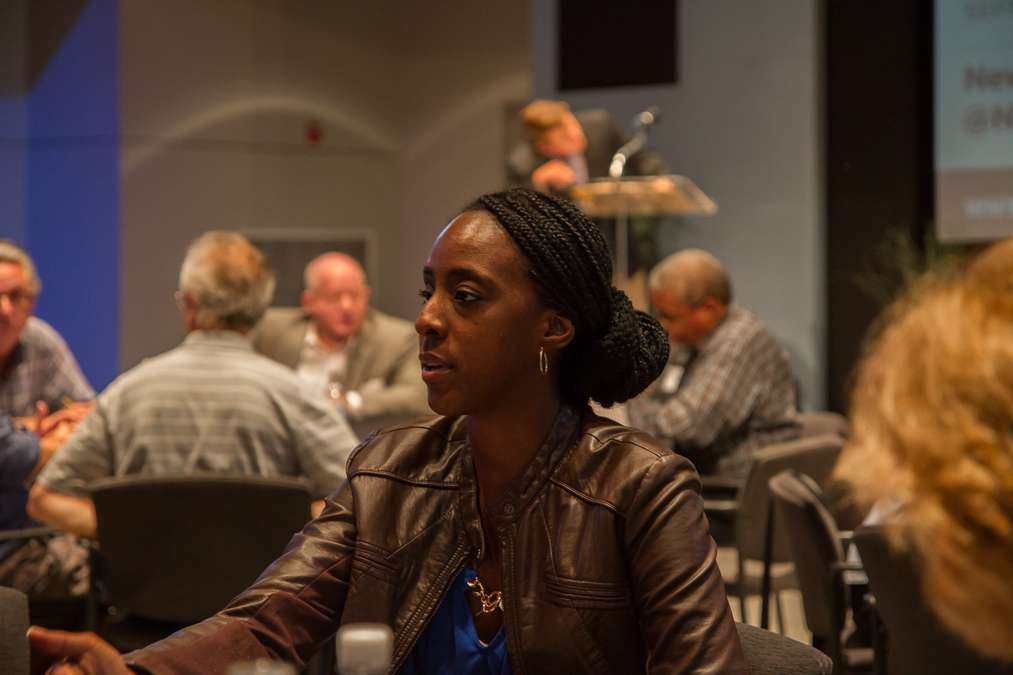 Audience members wrap up their small-group discussions before beginning the open forum. (Ifanyi Bell/for NewsWorks)