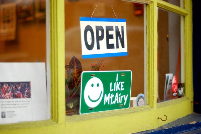 In this 2012, file photo a 'I like Mt Airy' sign sits behind a store front in the main retail district of Mt Airy on Germantown Avenue. (Bastiaan Slabbers for WHYY)