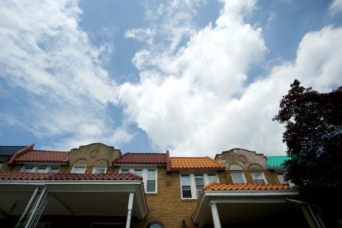 The roofs of these homes on Mower Street, in West Mt Airy are decorated in various colors. (Bastiaan Slabbers for WHYY)