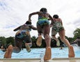 Kids jump into a pool