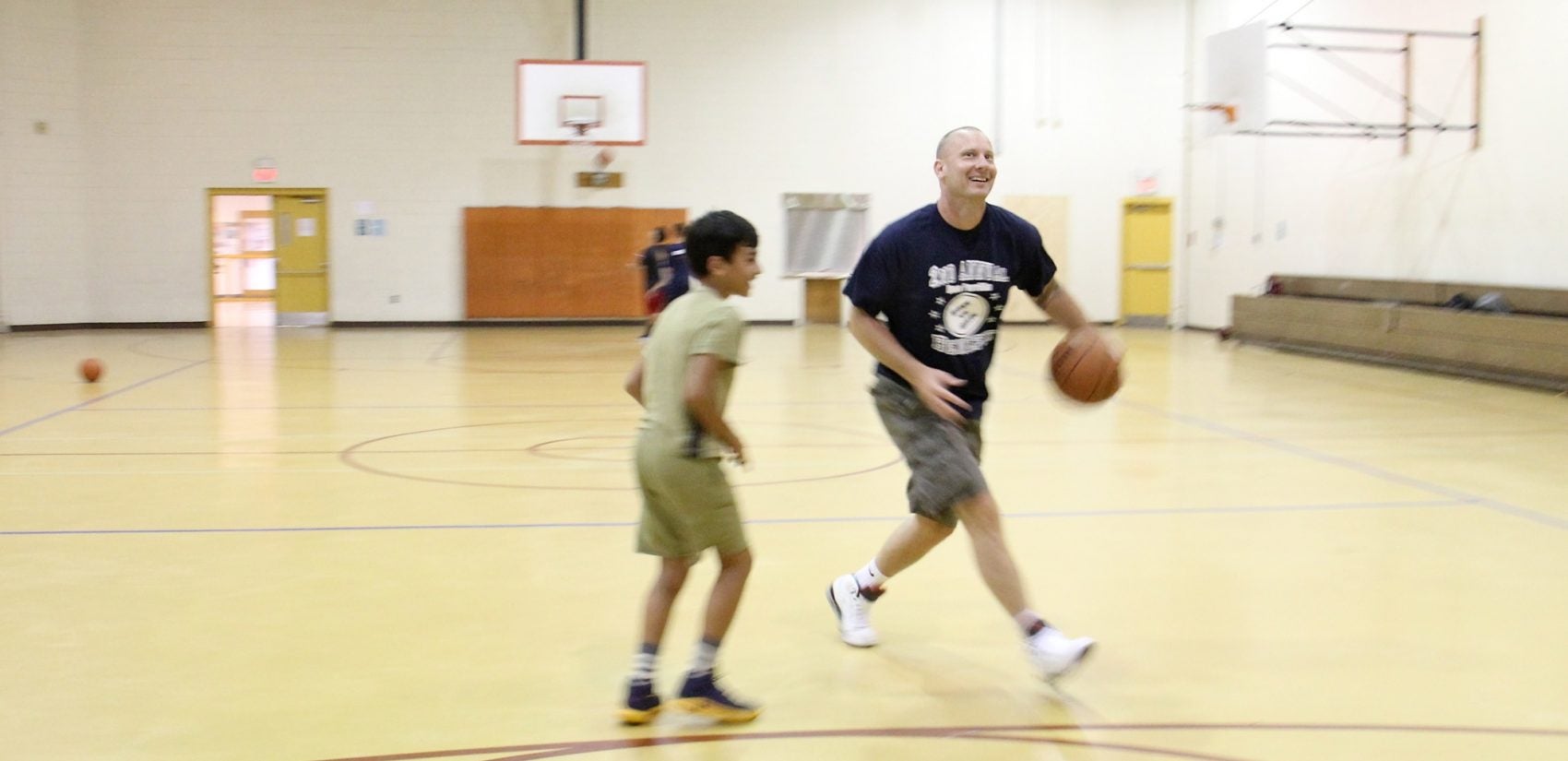 Anthony Famiglietti, coaching basketball at East Passyunk Community Rec Center.  (Emma Lee/WHYY)