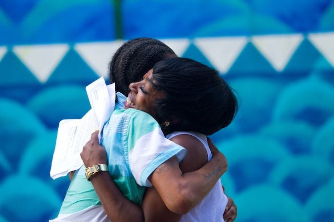 Storytellers Faith Bartley and Michelle Scales embrace during the performance. (Miguel Martinez/Every ZIP Philadelphia)