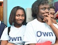 a young woman of color smiles at the camera