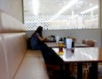 a woman sits alone at a cafe