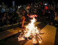 a protestor burns an American flag