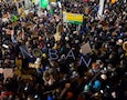 a crowd protests Trump's immigration ban