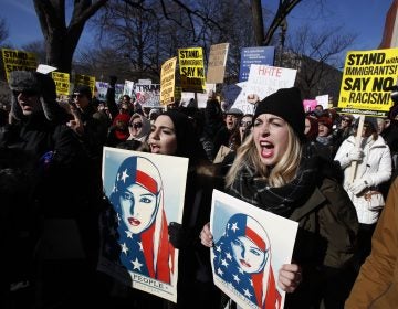 Martha Obermiller of Denver, right, chants during a rally protesting the immigration policies of President Donald Trump, near the White House in Washington, Saturday, Feb. 4, 2017.