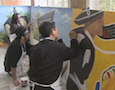 artists painting a mural
