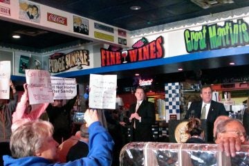 Gov. Christie (back right) looks away from protesters in Seaside Heights