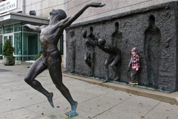 Zenos Frudakis' Freedom sculpture bursts from the wall of the Philadelphia Performing Arts charter high school on Vine Street. (Emma Lee/WHYY)