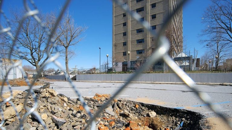  Bricks and debris are visible at one of the Potter's Field excavation sites behind the long-shuttered Queen Lane Apartments tower. (Bas Slabbers/for NewsWorks, file) 