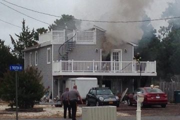 Smoke billowing from a house at 1 South Trenton Avenue in the Mystic Island section of Little Egg Harbor early Thursday afternoon. (Photo: JSHN contributor Rob Libonati)