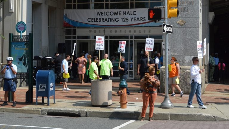  Members of the carpenters union protest outside the Pennsylvania Convention Center Monday. Postal workers are  having their annual meeting there. (Tom MacDonald/WHYY) 