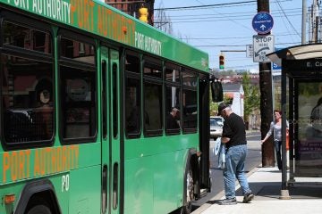  A passenger boards a Port Authority of Allegheny County bus in Pittsburgh.   (Ryan Loew/WESA) 