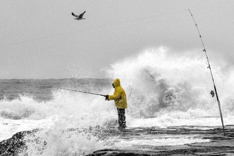  A fisherman on an Asbury Park, N.J. jetty during a stormy day in early November. (Photo:  JSHN contributor Robert Raia) 