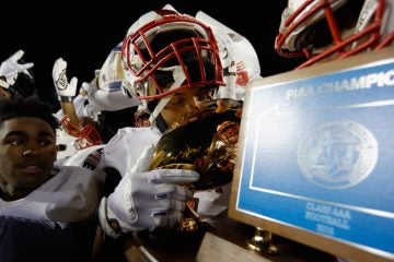 The PIAA AAA State Championship trophy is kissed by the players. (Bastiaan Slabbers/for NewsWorks)