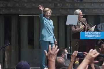 Hillary Clinton waves to the crowd on the Atlantic City boardwalk before a speech about Donald Trump's business record in that city. (Anthony Smedile for NewsWorks)