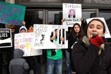 Yared Portillo of Juntos speaks at a rally outside 801 Market St. to call for the closing of the Berks County Residential Center, one of three centers in the country used to detain families whose immigration status is undetermined. (Emma Lee/WHYY)