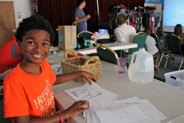 Gabe Robinson draws while other campers at White Pines Anime Camp learn about Japanese mythology. (Emma Lee/WHYY)