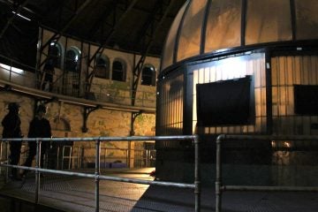 Guards stand outside the control room at the hub of Holmesburg Prison where the horror movie 'Death House' is being filmed. (Emma Lee/WHYY)