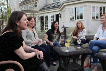 Book club members gather on the patio around author Nomi Eve. (Emma Lee/WHYY)