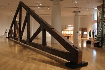 An 8,000-pound truss from the original roof of the Traction Company studio in West Philadelphia dominates the exhibit at PAFA. (Emma Lee/WHYY)