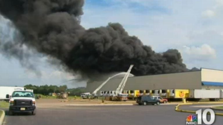  Thick, black smoke pours from the Dietz & Watson warehouse in Delanco, Burlington County. (Image from NBC10) 