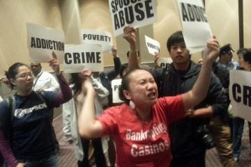  Protestors demonstrate at Tuesday's hearing on casino licensing in Philadelphia. (Tom MacDonald/WHYY) 