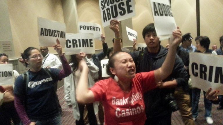  Protestors demonstrate at Tuesday's hearing on casino licensing in Philadelphia. (Tom MacDonald/WHYY) 