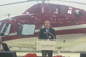  William Hunt of AgustaWestland stands in front of a $3.5 million helicopter his company built in Philadelphia (Tom MacDonald/for NewsWorks) 