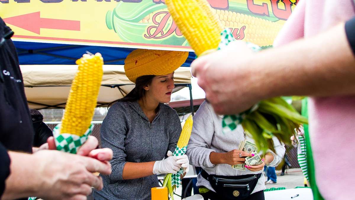   Jess Patrone serves roasted corn at the 'The Corn Lady' stand at the 2013 Manayunk StrEat Food Festival (Brad Larrison/for NewsWorks, file) 