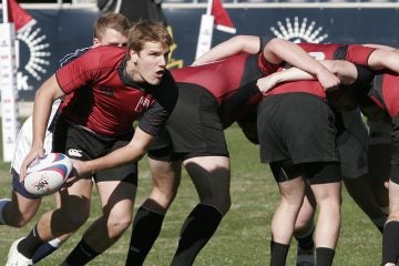 The Temple University scrum half is shown passing the ball out from the scrum in a rugby demonstration against Penn Sate University. (Mark Stehle/AP Images for USA 7's