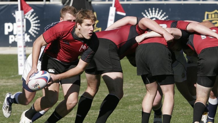 The Temple University scrum half is shown passing the ball out from the scrum in a rugby demonstration against Penn Sate University. (Mark Stehle/AP Images for USA 7's