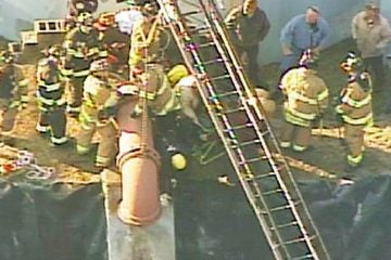  Crews working to get a man out of this water pipe. (Image via NBC New York) 