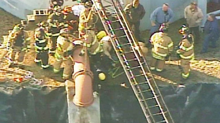  Crews working to get a man out of this water pipe. (Image via NBC New York) 