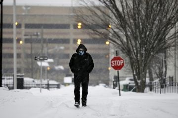  Bob Kay is bundled against the cold and snow as he walks in Trenton, N.J., Thursday, Feb. 13, 2014. (AP Photo/Mel Evans) 