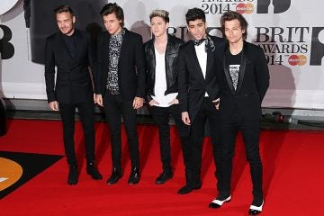  British band One Direction, from left, Liam Payne, Harry Styles, Niall Horan, Zayn Malik, and Louis Tomlinson arrive at the BRIT Awards 2014.  (File photo by Joel Ryan/Invision/AP) 