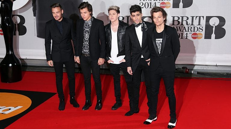 British band One Direction, from left, Liam Payne, Harry Styles, Niall Horan, Zayn Malik, and Louis Tomlinson arrive at the BRIT Awards 2014.  (File photo by Joel Ryan/Invision/AP) 