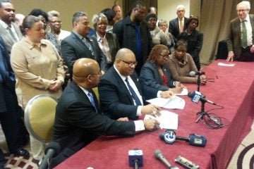  Philadelphia Mayor Michael Nutter and members of District Council 47 sign a deal that, if ratified, would continue through June 30, 2017. (Tom MacDonald/ for NewsWorks) 