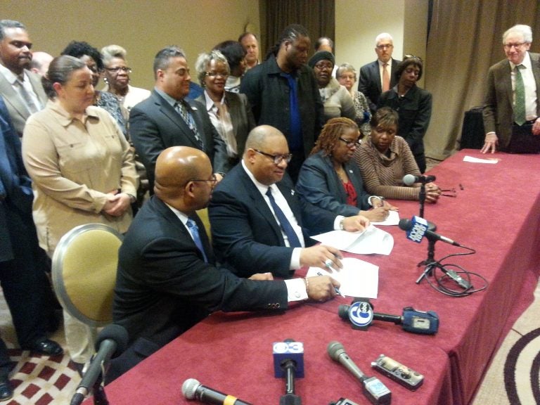  Philadelphia Mayor Michael Nutter and members of District Council 47 sign a deal that, if ratified, would continue through June 30, 2017. (Tom MacDonald/ for NewsWorks) 