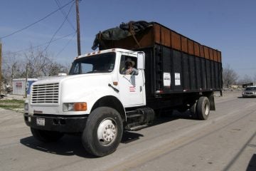  An AshBritt subcontractor hauls away Katrina. Ashbritt was later hired following Sandy in N.J.  (AP Photo/Rogelio Solis) 