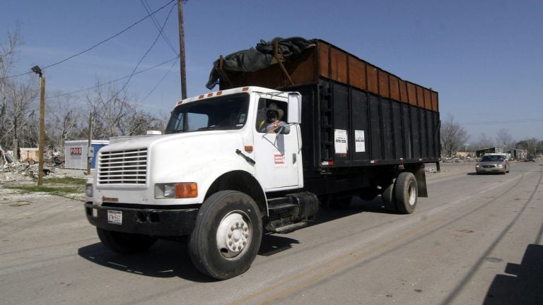  An AshBritt subcontractor hauls away Katrina. Ashbritt was later hired following Sandy in N.J.  (AP Photo/Rogelio Solis) 