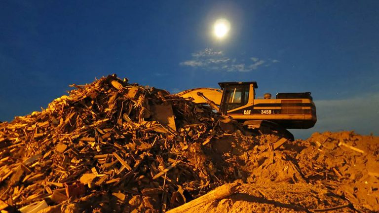  An excavator sits atop debris from Superstorm Sandy in Mantoloking. (Alan Tu/WHYY) 