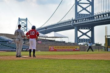  Dayton baseball player Mel Skochdopole (No. 10) stands on first base in an Atlantic 10 tournament game, with the Ben Franklin Bridge in the background on May 25, 2011 in Camden, N.J. (Photo via Shutterstock) 