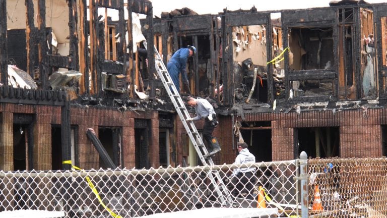  Investigators go through the rubble of a motel in Point Pleasant Beach N.J., on Saturday, March 22, 2014. (AP Photo/Wayne Parry) 